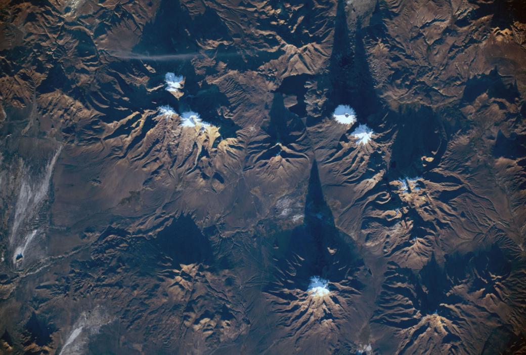 Mặt Trời lặn thấp dần ở chân trời khiến phần nhô cao của các ngọn núi lửa đổ bóng xuống mặt đất ngay bên cạnh. Ảnh được chụp từ ISS xuống vùng đất thuộc Công viên Quốc gia Sajama của Bolivia vào 19/05/2019.