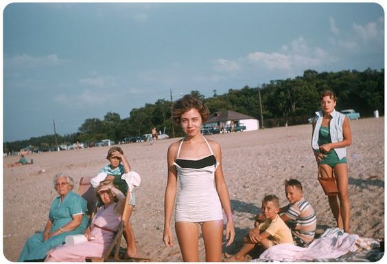 this is what a stunning bathing suit looked like in 1956 with ever so curious boys in the background