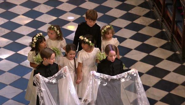 two page boys held meghan markles five metre long veil as the excited flower girls followed behind them