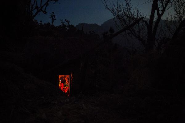 a chhaupadi hut by firelight at night many women keep using them out of pressure and a sense of obligation