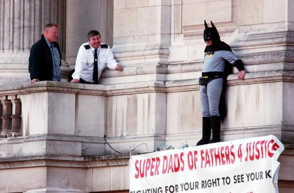 a fathers 4 justice campaigner dressed as batman on a balcony of buckingham palace