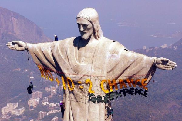 activists from the environmental organization greenpeace rappel from a statue of christ the redeemer in rio de janeiro