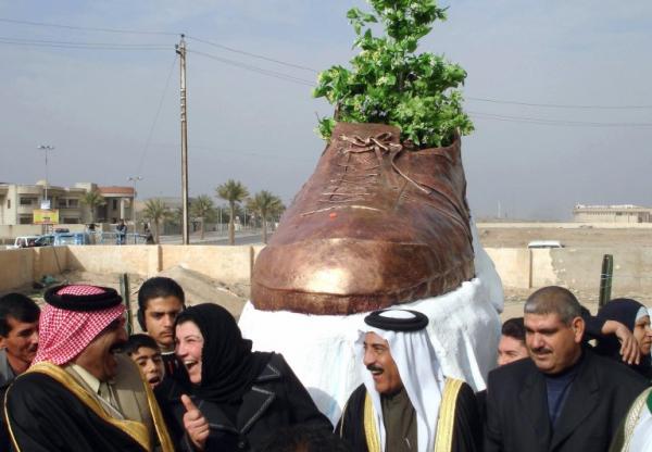 iraqi officials unveil a bronze shoe monument representing the one thrown by iraqi journalist muntazer al zaidi at former us president george w bush
