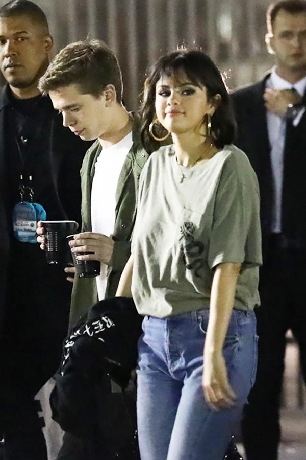 selena gomez goes braless leaves taylor swift concert with mystery man post1 gallery