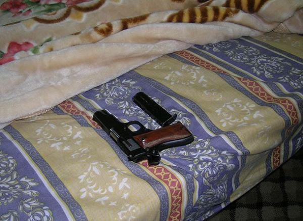 gun on bed 610x445