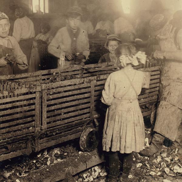 scene in canning factory showing a 7 year old girl who shucks 3 pots of oysters a day