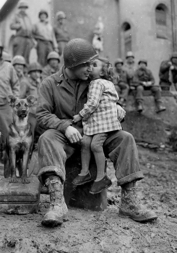 a little french girl gives an american soldier a kiss on valentines day 1945