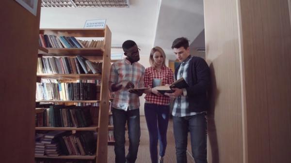 three people standing in the library and talking about the books btw9cpqwke thumbnail medium08