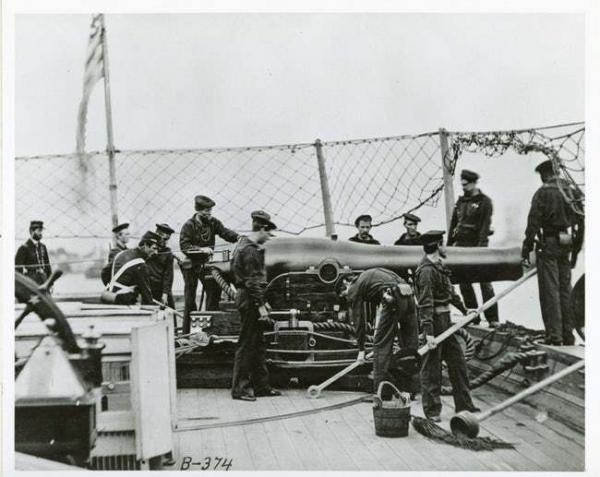 soldiers check out a cannon mounted on a u s naval warship photo u1