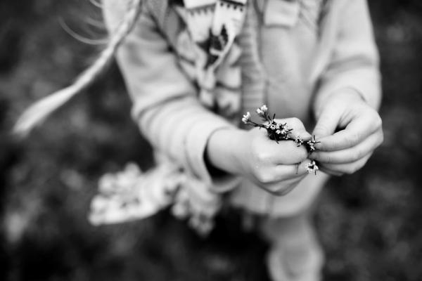 black and white pic of child holding wild flowers by cynthia dawson