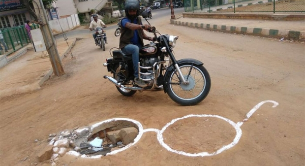 man draws attention to messed up roads in best way possible xx photos 13